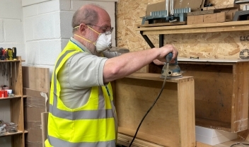 upcycling-house-volunteer-sanding-a-piece-of-furniture