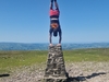 person-doing-handstand-on-top-of-a-mountain-peak