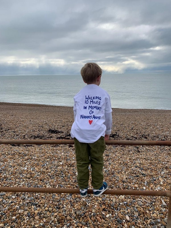 howard-standing-on-rails-in-front-of-the-beach