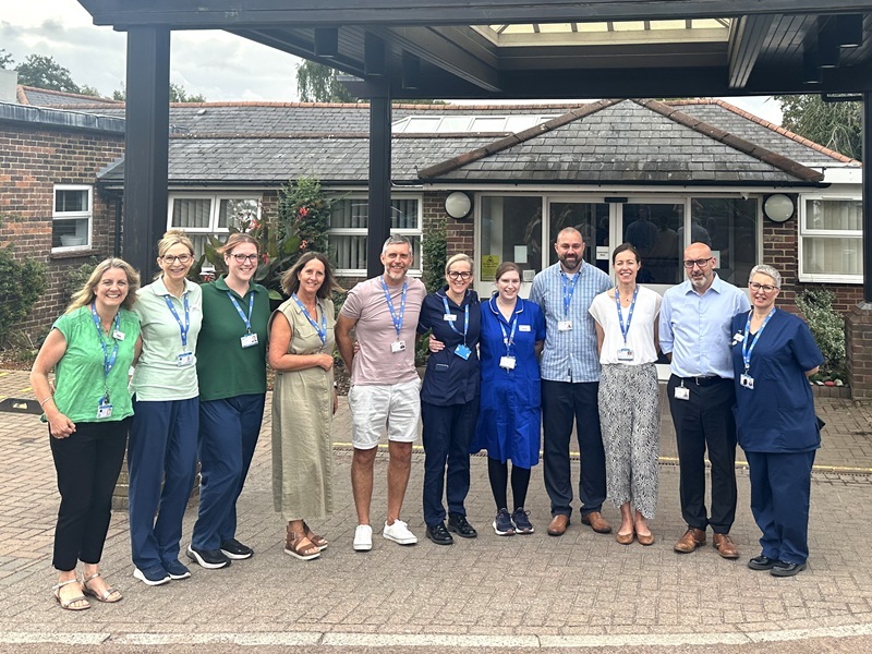 group-of-hospice-staff-standing-outside-the-front-entrance