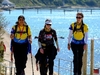 three-trekkers-smiling-and-walking-toward-camera-at-the-isle-of-wight-ultra-challenge