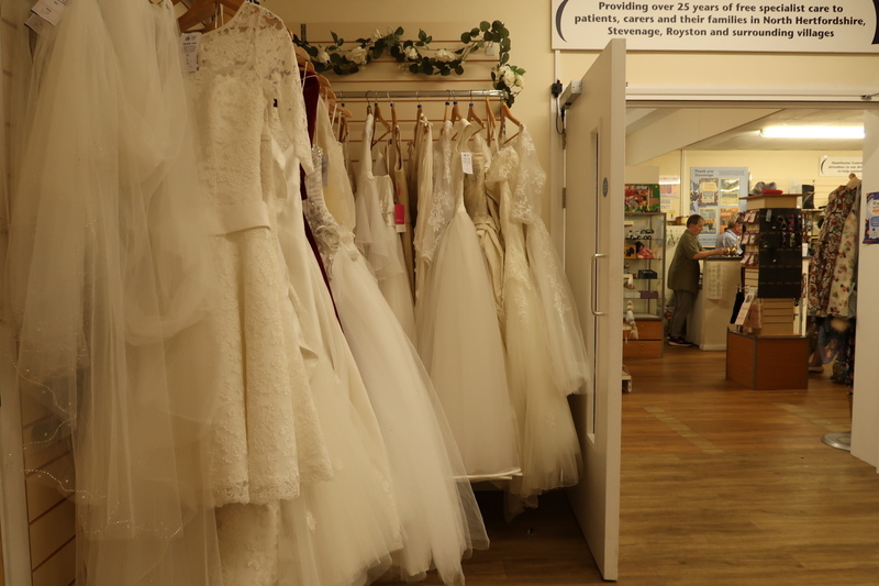 wedding-dresses-hanging-from-a-clothes-rail-in-a-shop