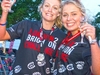 two-participants-cheers-a-glass-of-bubbly-and-wear-finishers-medals-at-the-london-2-brighton-ultra-c