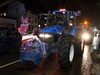 a-blue-tractor-with-a-reindeer-cutout-stuck-on-its-front