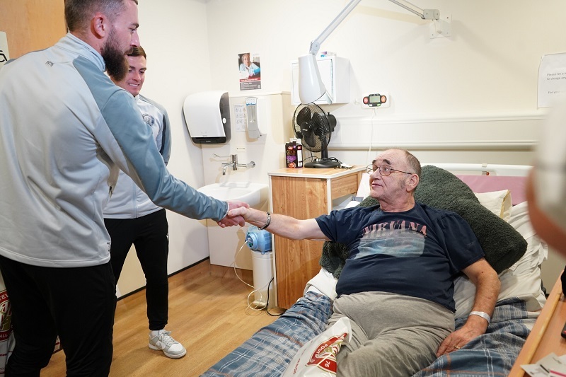 stevenage-player-shakes-hands-with-patient-on-ipu