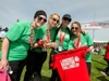 a-group-of-four-wearing-matching-tops-and-their-medals-at-the-london-2-brighton-ultra-challenge-fini