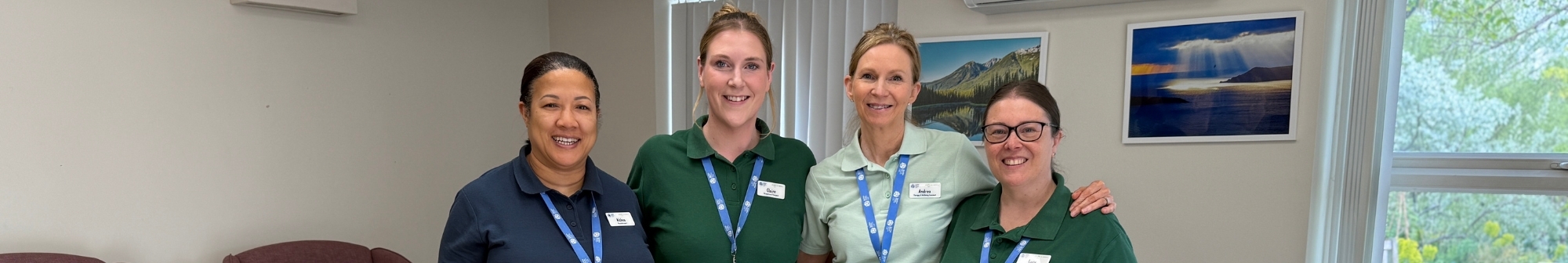rehab-and-wellbeing-team-stand-in-a-line-smiling