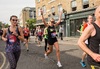 woman-running-through-hackney-cheering-with-arms-in-air