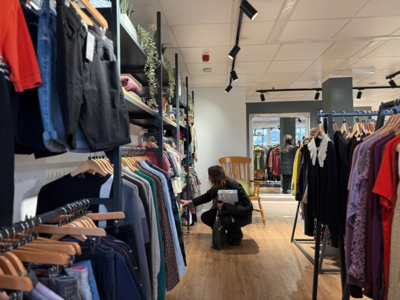 a-customer-browsing-clothes-rails-at-our-fairfield-shop