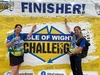 two-finishers-pose-on-stage-at-the-isle-of-wight-ultra-challenge