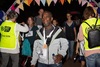 man-smiles-as-he-crosses-finish-line-with-medal-round-his-neck