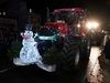 a-wire-lit-up-snowman-on-the-front-of-a-tractor