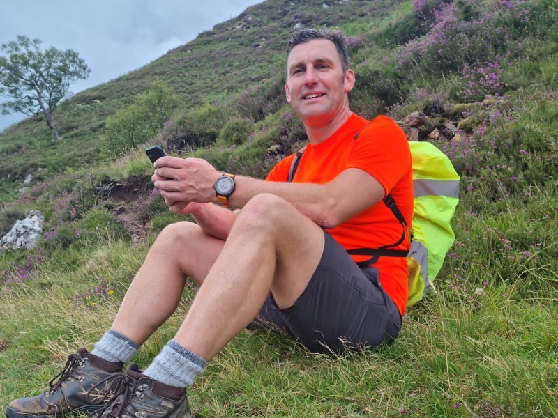 man-sits-on-grass-and-rests-during-national-3-peaks-challenge