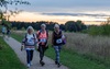 three-ladies-walk-as-the-sun-sets-behind-them