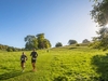 two-runners-jog-through-a-field-on-the-north-downs-50-ultra-challenge