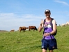 a-participant-gives-a-thumbs-up-to-the-camera-with-cows-in-the-background-on-the-lake-district-ultra