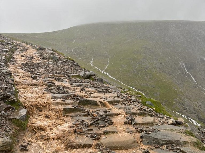 view-of-a-mountain-path-surrounded-by-clouds-and-fog