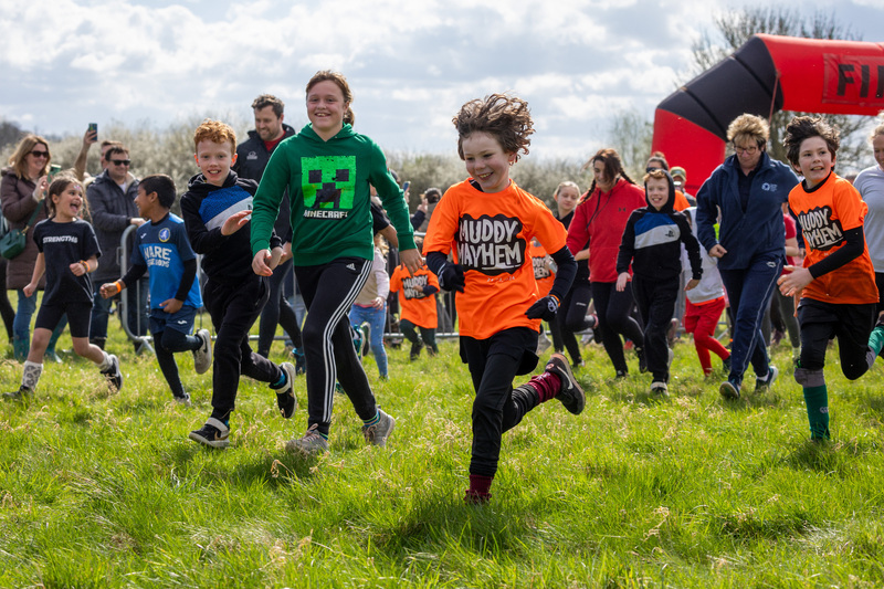 youngsters-smiling-and-running-the-mini-mudder-course