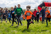 youngsters-smiling-and-running-the-mini-mudder-course