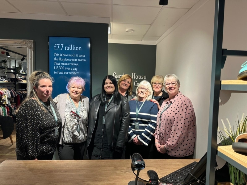 staff-and-volunteers-smile-behind-the-till-at-our-fairfield-shop