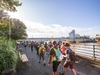 participants-walk-away-from-camera-alongside-the-river-on-the-thames-bridges-trek