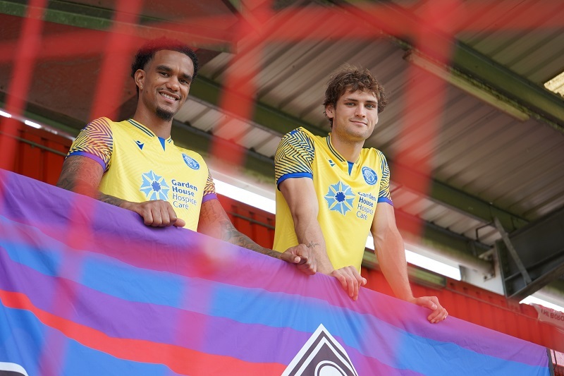 stevenage-fc-players-smiling-in-third-kit-at-lamex-stadium