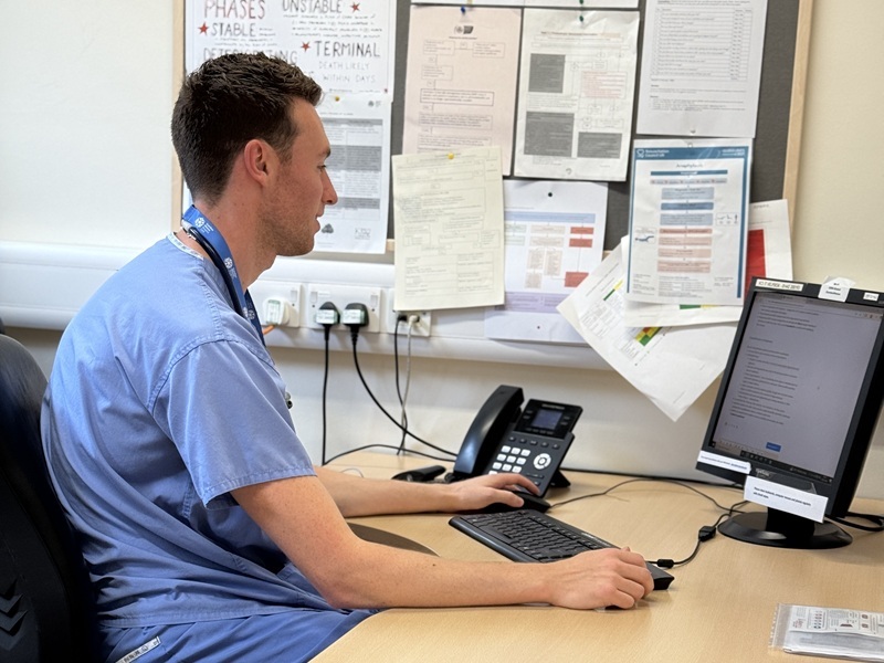 doctor-scrolling-through-notes-on-a-computer