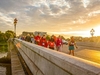 participants-crossing-a-bridge-as-the-sun-sets-on-the-thames-path-ultra-challenge