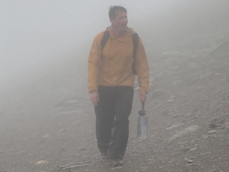 man-walking-through-fog-carrying-a-bottle-of-water