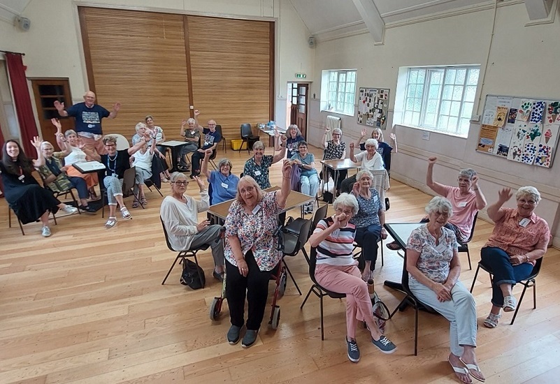 members-and-volunteers-inside-the-church-waving-at-the-camera