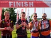 four-south-coast-ultra-challenge-participants-at-the-finish-line-with-their-medals-and-fizz