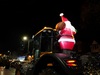 an-inflatable-santa-claus-on-the-back-of-a-tractor