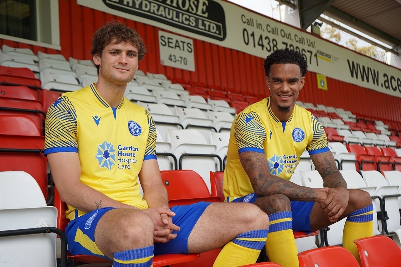 stevenage-footballers-wearing-full-third-team-kit-sitting-in-stadium