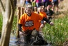 participant-wades-through-thigh-high-mud-at-muddy-mayhem