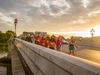 thames-bridges-trek-participants-cross-a-bridge-as-the-sun-sets