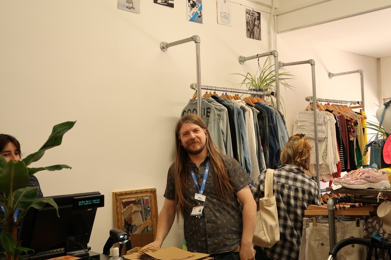 threads-shop-manager-peter-smiles-standing-next-to-till