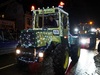 a-yellow-tractor-covered-in-christmas-lights-and-hats