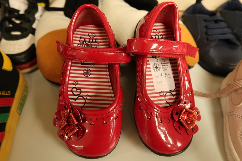 a-pair-of-red-childrens-shoes-on-a-shop-shelf