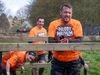 a-team-clamber-over-and-under-hurdles-at-muddy-mayhem