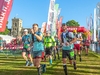 participants-wave-as-they-run-through-the-start-line-of-the-south-west-coast-50-ultra-challenge