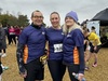 three-runners-stand-smiling-before-start-of-herts-half-10k