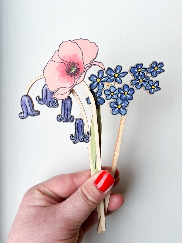 hand-holding-up-wooden-wildflower-decorations
